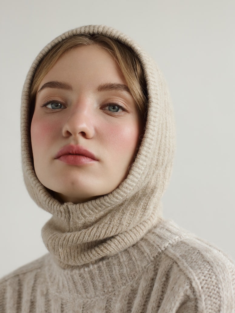 Young beautiful woman wearing knitted hood and sweater