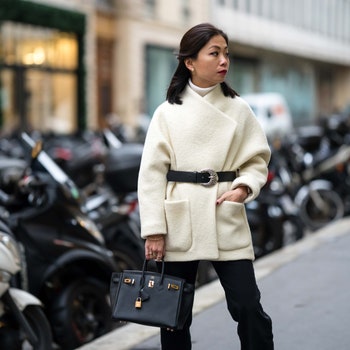 PARIS FRANCE  NOVEMBER 30 May Berthelot wears gold earrings from Leo Sedim a white ribbed wool turtleneck pullover a...