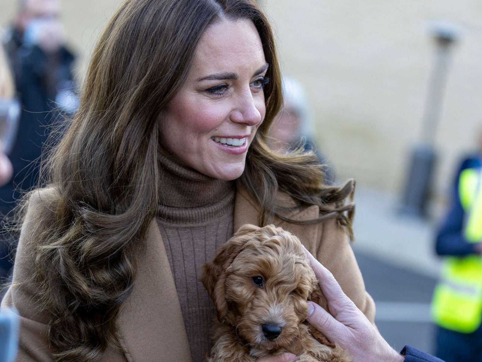 Britain's Catherine Duchess of Cambridge holds a therapy puppy before unveiling it's name Alfie to members of staff...