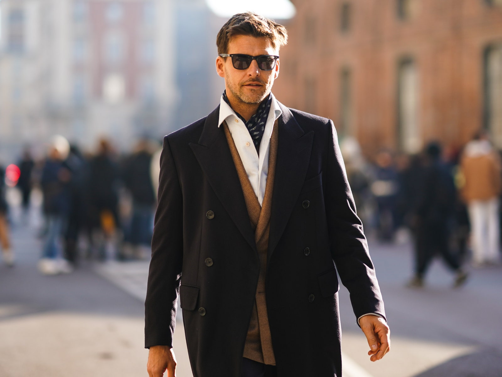 MILAN ITALY  JANUARY 12 Johannes Huebl wears sunglasses a scarf a white shirt a light brown blazer double breasted...